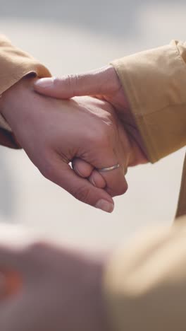 Vertical-Video-Close-Up-Shot-Of-Loving-Muslim-Couple-On-Date-Holding-Hands